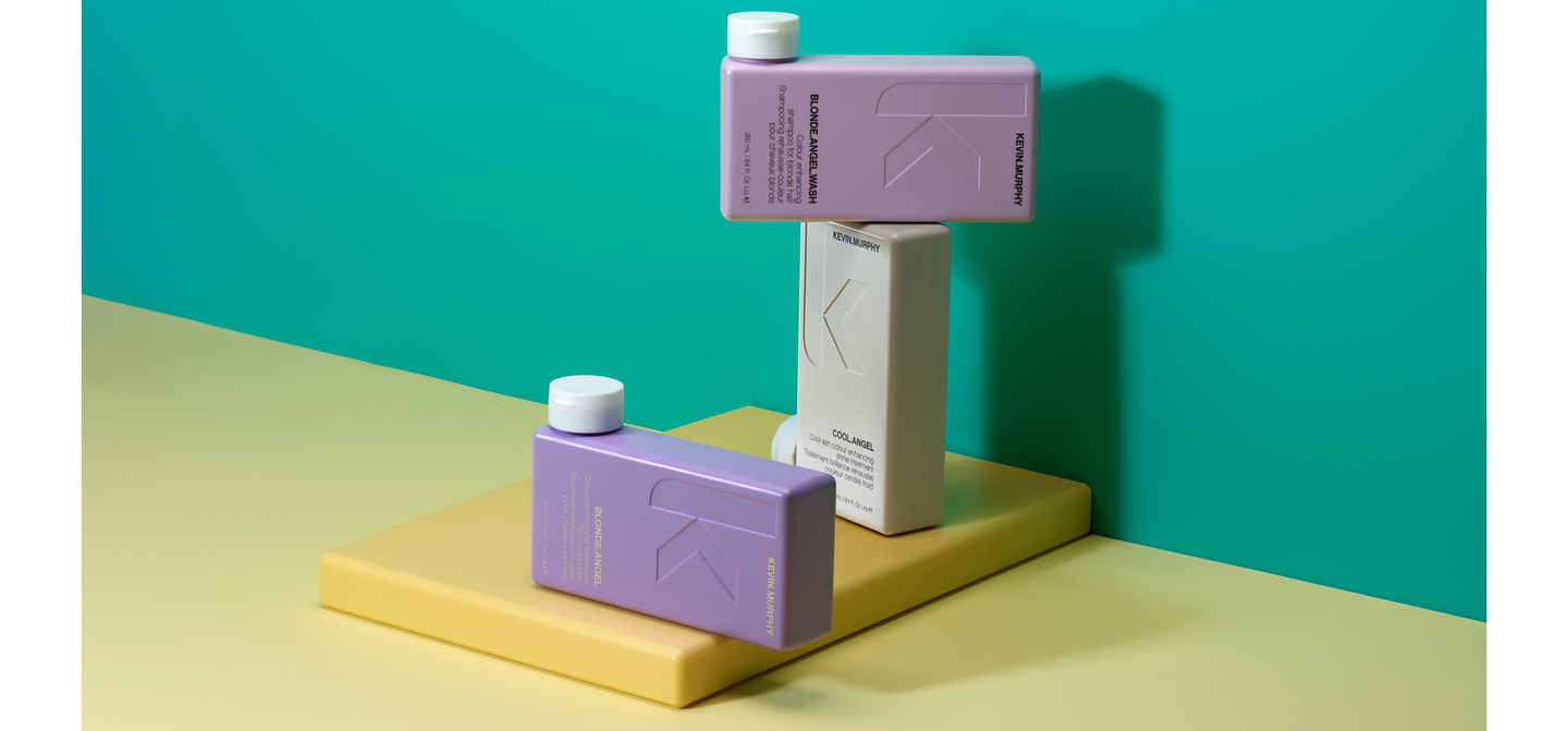 Kevin Murphy BLONDE.ANGEL.WASH and COOL.ANGEL bottles on color blocks against a teal backdrop.